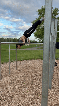 Young athlete practices handstands at outdoor gym in Viernheim