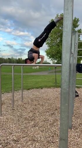 Young athlete practices handstands at outdoor gym in Viernheim