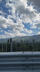 Snow-capped mountain vista captured from Sofia highway guardrail