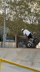 BMX rider performs at concrete skate park in Badalona