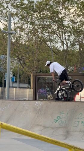 BMX rider performs at concrete skate park in Badalona
