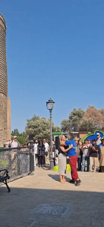 Live music and dancing near a historic tower in Baku