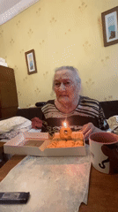 Elderly woman celebrates birthday in Moscow home