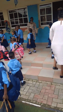 School children in uniforms gathered at Idimu facility