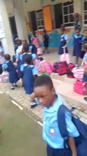 School children in uniforms gathered at Idimu facility