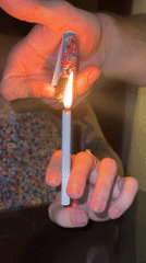 Two people share cigarette lighting moment in Baan Chaweng