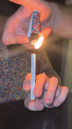 Two people share cigarette lighting moment in Baan Chaweng