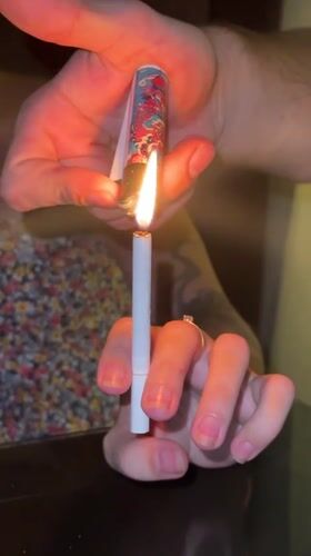 Two people share cigarette lighting moment in Baan Chaweng