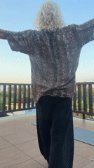 Person observed on terrace amid tropical setting