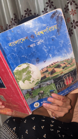 Student holds Bangladesh studies textbook in Hizla