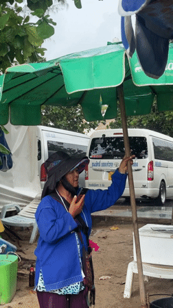 Patong Beach morning scene with chairs, umbrellas, families