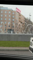Rainy day fountain view captured from car in Belgrade