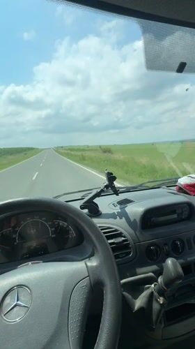 Driver travels two-lane road in Mercedes van near Madara