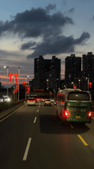 Evening traffic flows past red lanterns in Nanshan District