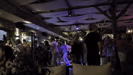 Outdoor nightclub dancing under purple lights in Varna