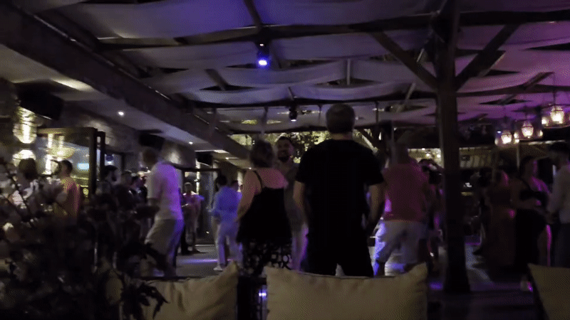 Outdoor nightclub dancing under purple lights in Varna