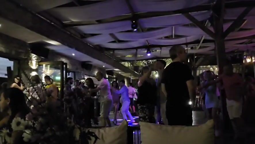 Outdoor nightclub dancing under purple lights in Varna