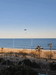 Paraglider soars over Mediterranean near Calella, Spain