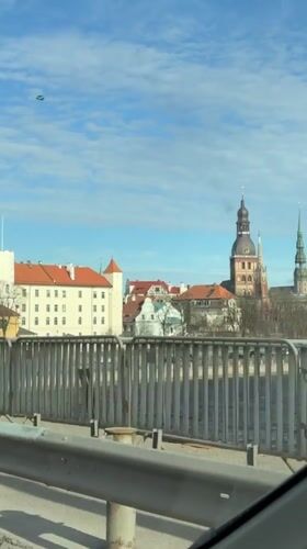 Daytime cityscape of Riga captured from moving vehicle