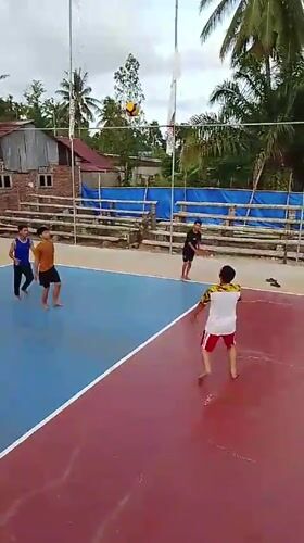 Volleyball and rice paddy work at sunset in rural Aceh
