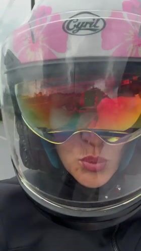 Woman rides motorcycle through Ko Kaeo, Thailand streets