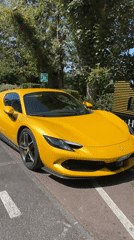 Yellow Ferrari parked roadside in Étretat, Normandy