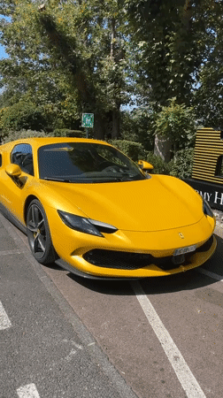 Yellow Ferrari parked roadside in Étretat, Normandy