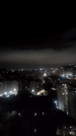 Nighttime cityscape captured from elevated view in Caracas