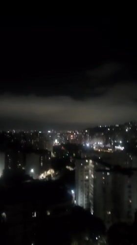 Nighttime cityscape captured from elevated view in Caracas