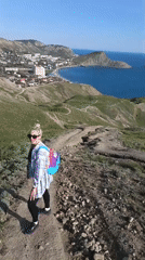 Hilltop gathering overlooked coastal town, drinks and sightseeing captured