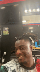Customer records selfie video during barbershop visit in Arlington