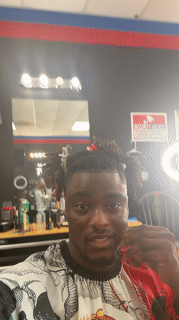 Customer records selfie video during barbershop visit in Arlington