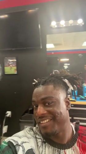 Customer records selfie video during barbershop visit in Arlington