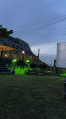 Backyard movie screening shows black and white film at dusk