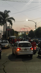 Red-clad crowd gathers for evening procession in Lanús Este
