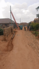 Routine street life documented along dirt roads in Jos, Nigeria
