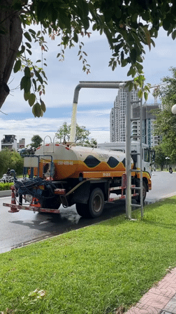 Morning maintenance at a Hanoi residential park complex