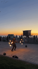 Fire performer draws crowds at sunset beach in Batumi