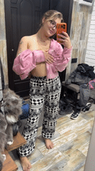 Woman records mirror selfies with cat in Russian home