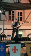 Rock band performs under heraldic banners on Buenos Aires outdoor stage