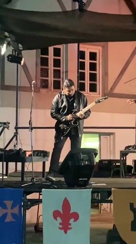 Rock band performs under heraldic banners on Buenos Aires outdoor stage