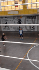 Men play recreational volleyball in Krasnoyarsk sports facility