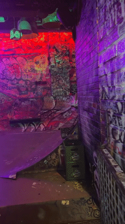 Inside a gritty, graffiti-covered Barcelona bar at night
