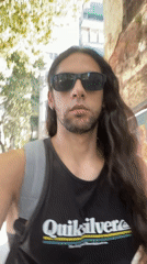 Man films selfie video while walking Buenos Aires sidewalk