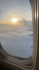 Passenger films sunrise from airplane window over Poland
