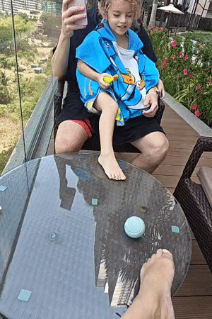 Father and child enjoy early morning swim in Mumbai rooftop pool