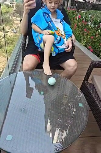 Father and child enjoy early morning swim in Mumbai rooftop pool