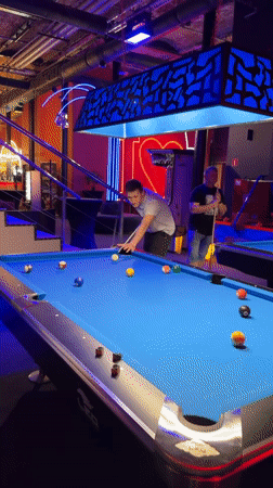 Man plays pool at billiards venue in Łódź
