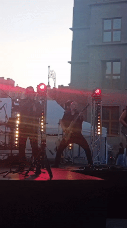 Rock band plays Wrocław's Rynek at dusk
