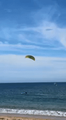 Water sports enthusiast kitesurfs, wing foils off Barbate coast